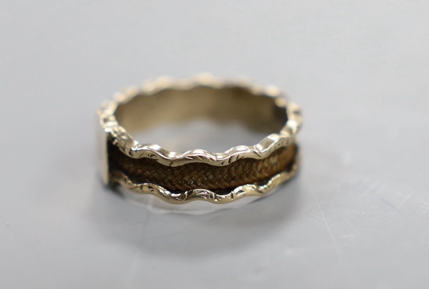 A 19th century yellow metal and plaited hair set band, the ring head with engraved monogram, size M/N, gross weight 1.8 grams.